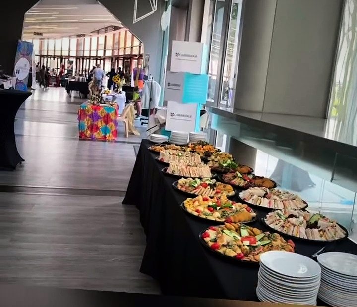 A long buffet set up in a bright event hall