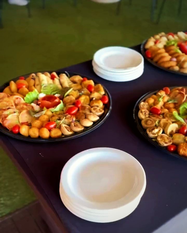 Finger-food platters set out on an outdoor table