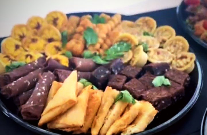A platter of quiches, brownies, samoosas and savoury bites