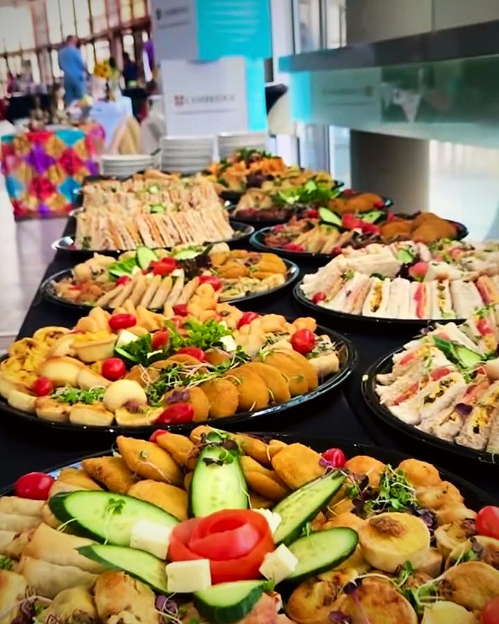 Platters of sandwiches, pastries and salads at a school celebration